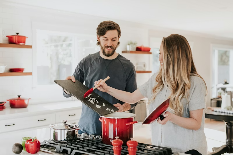 Couple making pizza in the kitchen